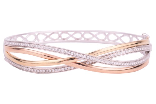 Lot 123 - A tri-coloured hinged bracelet in braided...