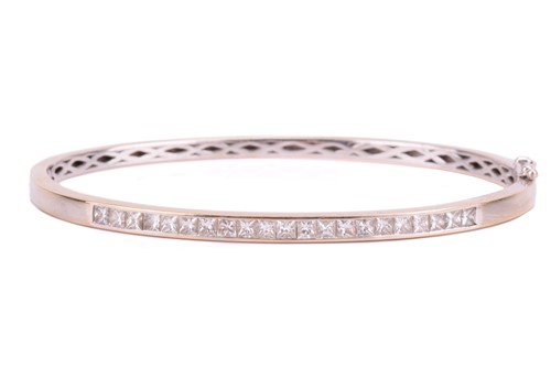 Lot 216 - A diamond-set hinged bracelet in 18ct white...