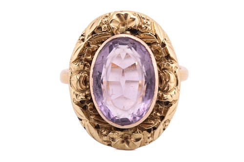 Lot 28 - An amethyst dress ring, comprising an oval-cut...