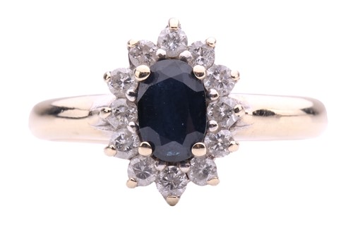 Lot 142 - A sapphire and diamond oval cluster ring set...