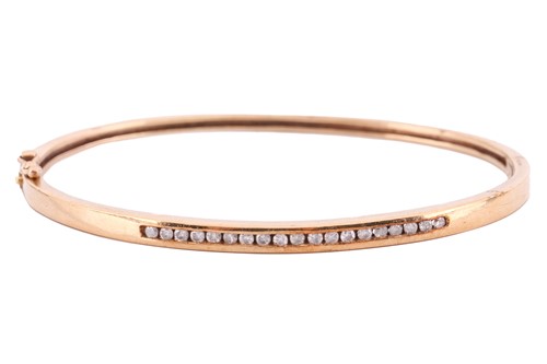 Lot 55 - A diamond-set hinged bracelet in 9ct yellow...