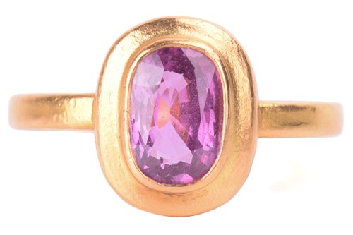 Lot 58 - A purple sapphire solitaire ring, the oval...