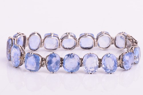 Lot 98 - A Ceylon sapphire bracelet, set with a row of...