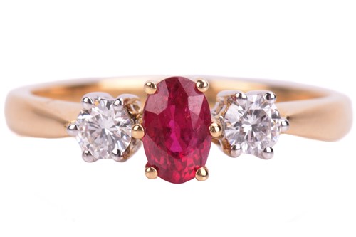 Lot 24 - A ruby and diamond trilogy ring in 18ct yellow...