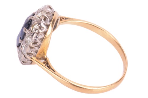 Lot 75 - A sapphire and diamond cluster ring. Oval-cut...
