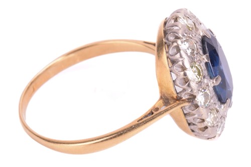 Lot 75 - A sapphire and diamond cluster ring. Oval-cut...