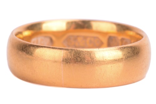 Lot 91 - A 22ct court shape wedding ring, ring size K,...