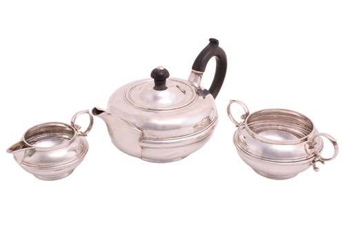 Lot 412 - A silver three piece tea service, of squat...