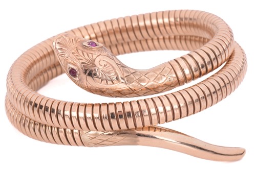 Lot 145 - A serpent double row flexible bangle with gem...