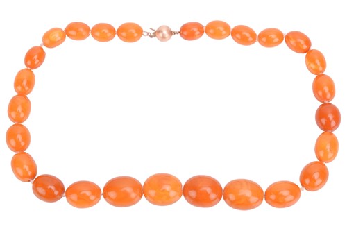 Lot 231 - A butterscotch oval amber bead necklace...