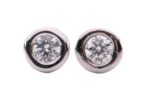 Lot 63 - A pair of diamond stud earrings, each...