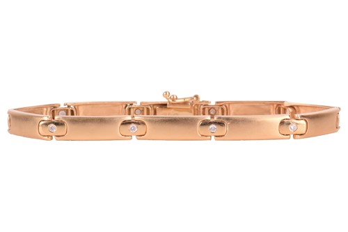 Lot 6 - A diamond-set line bracelet in satin finish,...