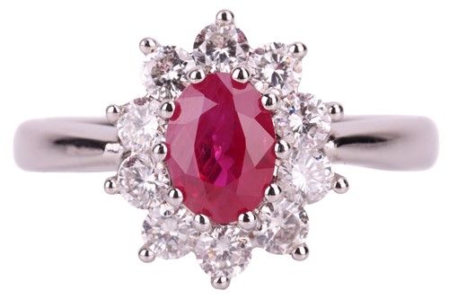 Lot 56 - A ruby and diamond halo ring in 18ct white...