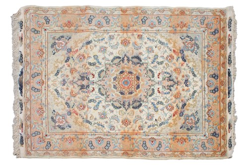 Lot 192 - A graduated ivory and peach ground Tabriz rug...
