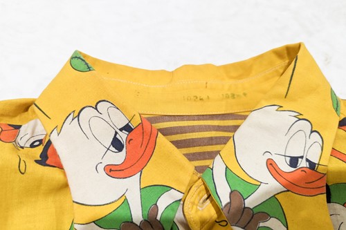 Lot 329 - A 1960s beagle-collared yellow shirt, from the...