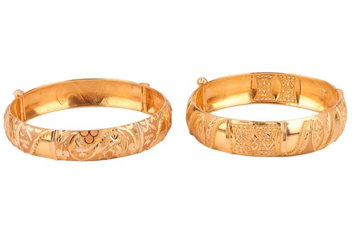 Lot 86 - Two Indian hinged bracelets, both constructed...