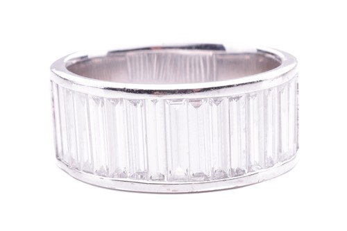 Lot 21 - A baguette diamond-set half eternity ring,...