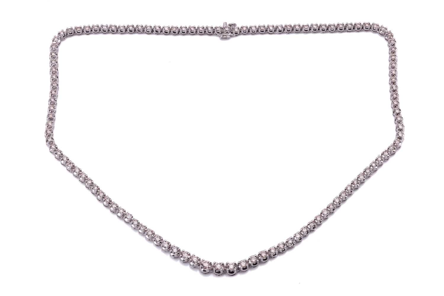 Lot 94 - A diamond line necklace set with a single row...