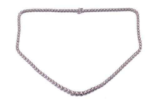 Lot 94 - A diamond line necklace set with a single row...