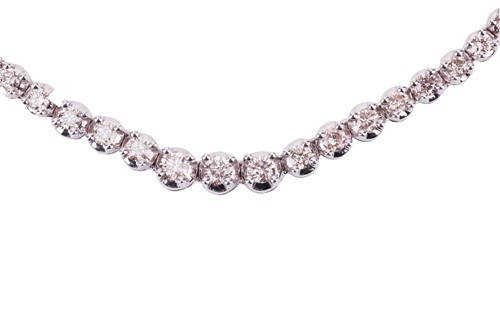 Lot 94 - A diamond line necklace set with a single row...
