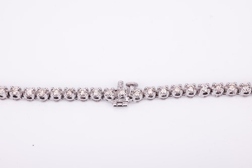 Lot 94 - A diamond line necklace set with a single row...