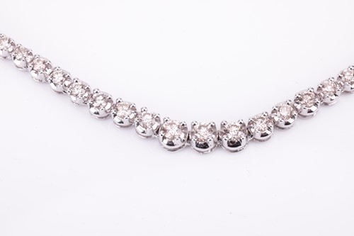 Lot 94 - A diamond line necklace set with a single row...