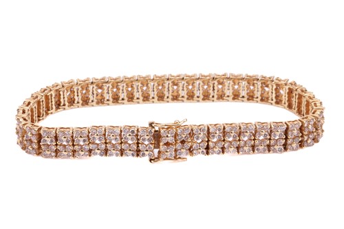Lot 21 - A diamond-set link bracelet in 18ct yellow...