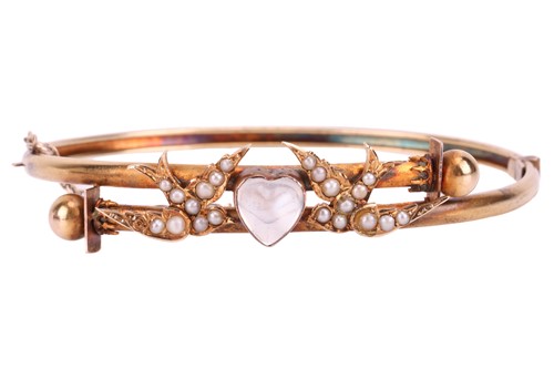 Lot 60 - A moonstone and seed pearl swallow bangle, set...