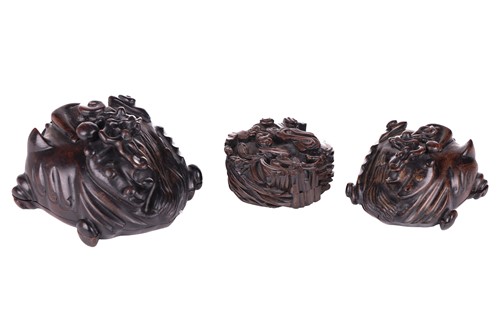 Lot 60 - A Chinese carved wood-lidded box in the form...
