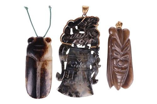 Lot 51 - A Chinese carved variegated dark green jade...