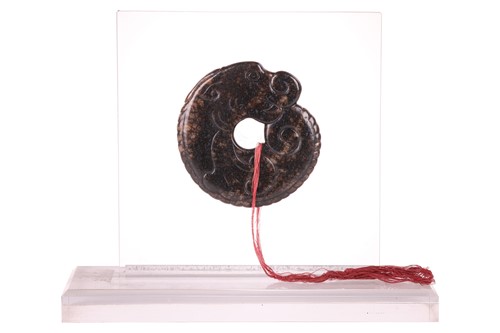Lot 58 - A Chinese archaistic carved brown/ black jade...