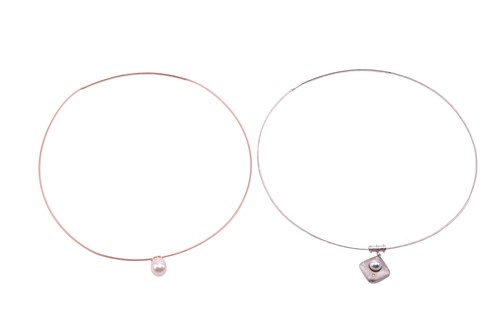 Lot 193 - Two cultured pearl pendant wire necklaces; the...