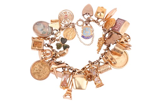 Lot 52 - A charm bracelet in 9ct gold, with a variety...