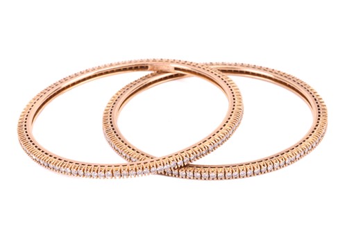 Lot 91 - A pair of diamond bangles, each set with a...