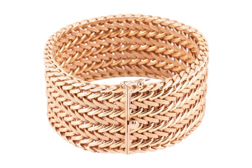 Lot 35 - A wide woven link bracelet, flat with textured...
