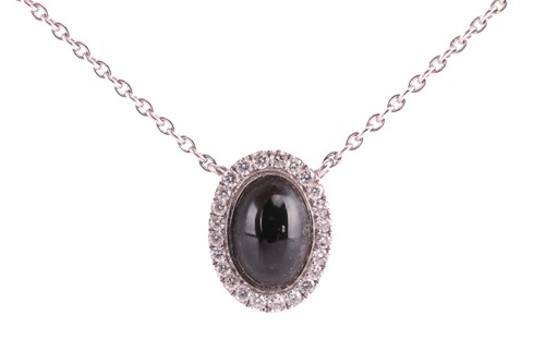 Lot 8 - A jet and diamond halo pendant, set in 18ct...