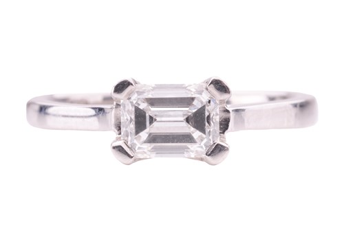 Lot 115 - A diamond solitaire ring, featuring an emerald-...