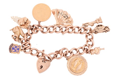 Lot 44 - A 9ct gold charm bracelet featuring nine...