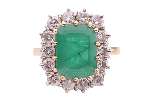 Lot 122 - An emerald and diamond cluster ring, set with...