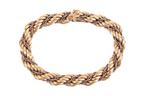 Lot 98 - A twisted rope bracelet in 18ct bi-coloured...
