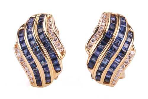 Lot 108 - A pair of gem-set earclips, the curved rows...