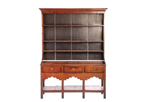 Lot 110 - A George III oak pot board dresser and Delft...