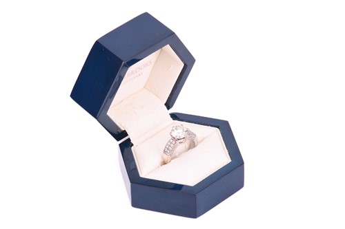 Lot 106 - A diamond solitaire ring with diamond set...