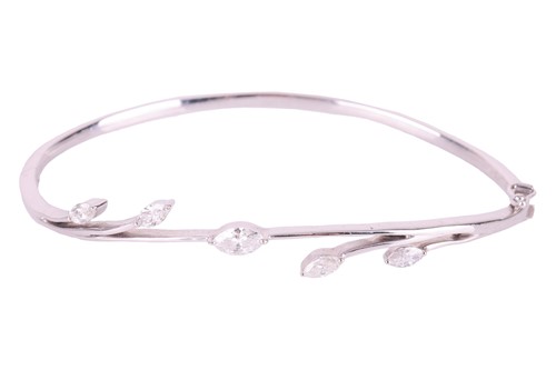 Lot 120 - A diamond bangle in a foliate design set with...