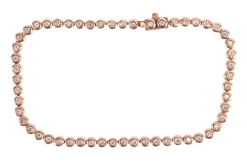 Lot 156 - A diamond tennis bracelet, set with a...