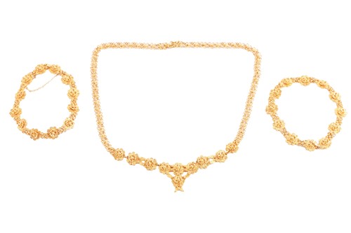 Lot 26 - An Ashanti necklace and bracelets suite,...