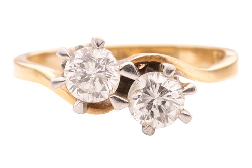Lot 42 - A diamond two stone cross-over ring, featuring...