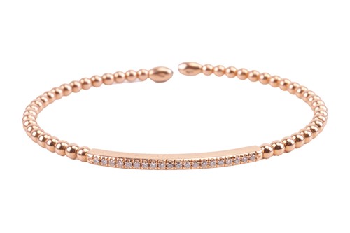 Lot 90 - A diamond-set torque bangle, comprising of an...