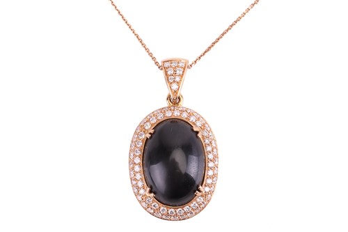 Lot 88 - A large Whitby jet and diamond halo pendant on...