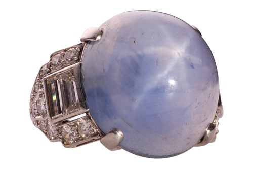 Lot 137 - A star sapphire and diamond ring, circa 1950s,...